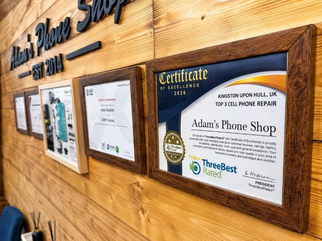 Framed certificates on the wall at Adam's Phone Shop in Hull, including ThreeBestRated Top 3 and GSMR training