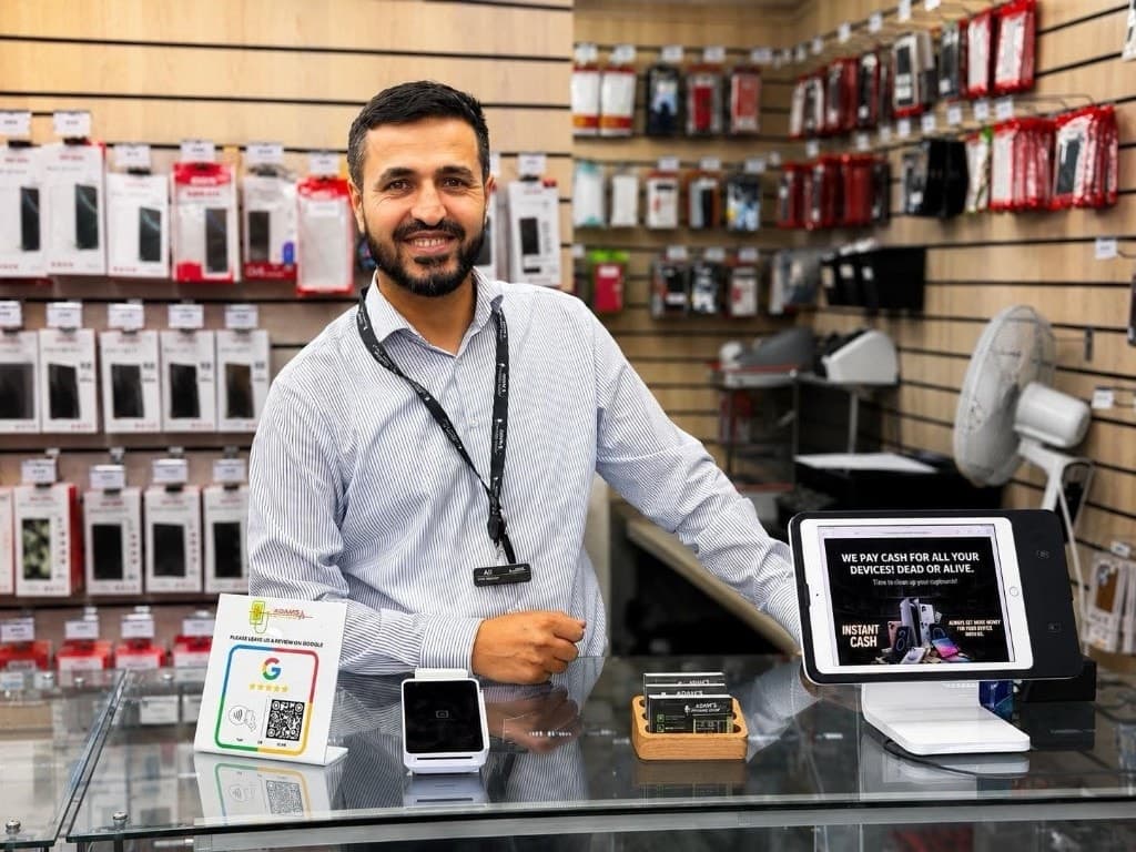 Adam's Phone Shop staff member at the service counter in Hull