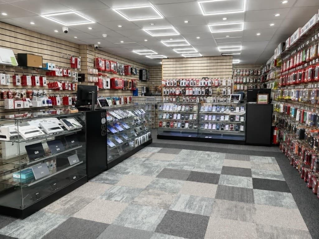 Interior of Adam's Phone Shop showing display counters and accessory walls
